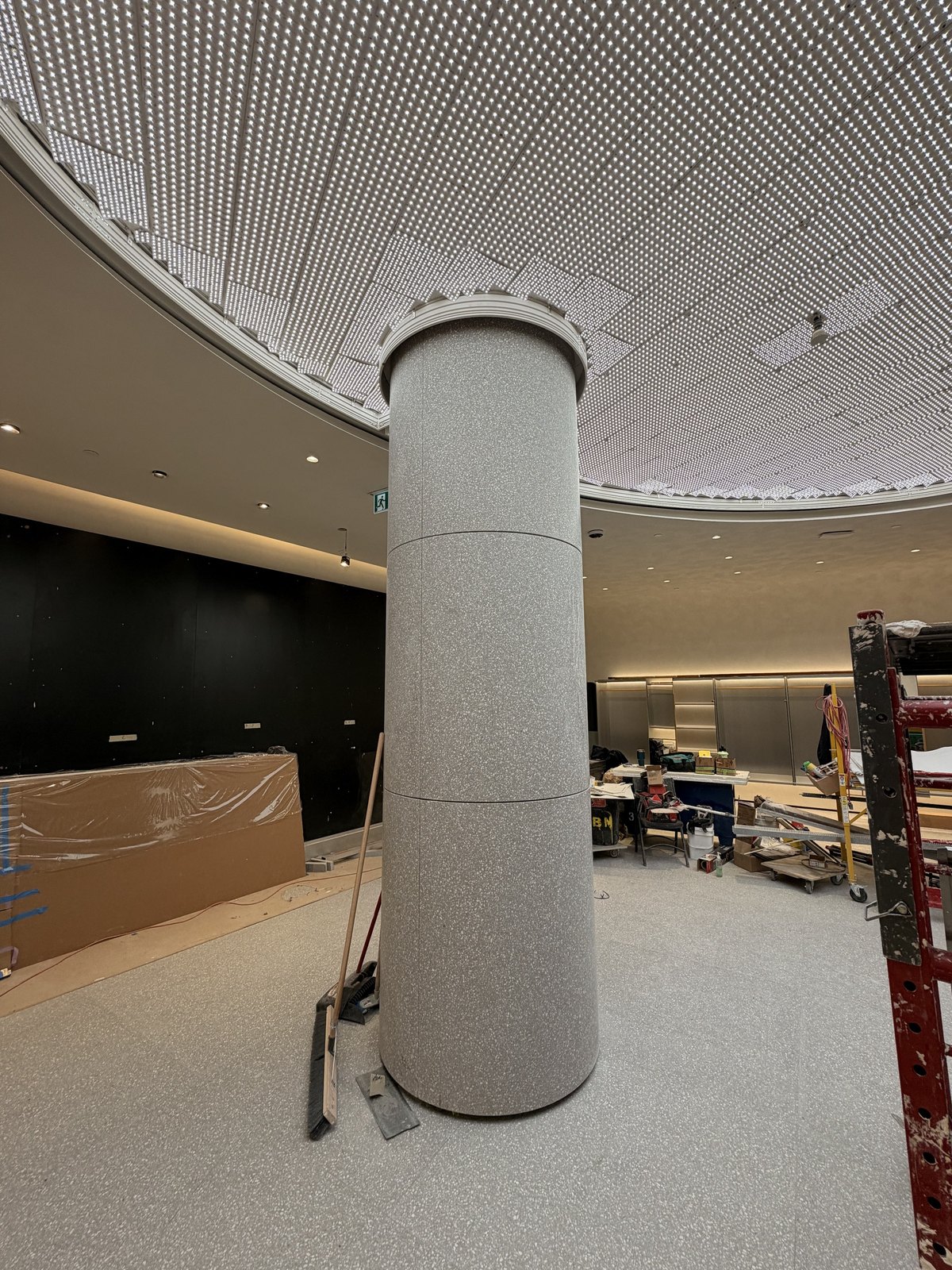Commercial interior fit-out in progress with custom stone column and flooring